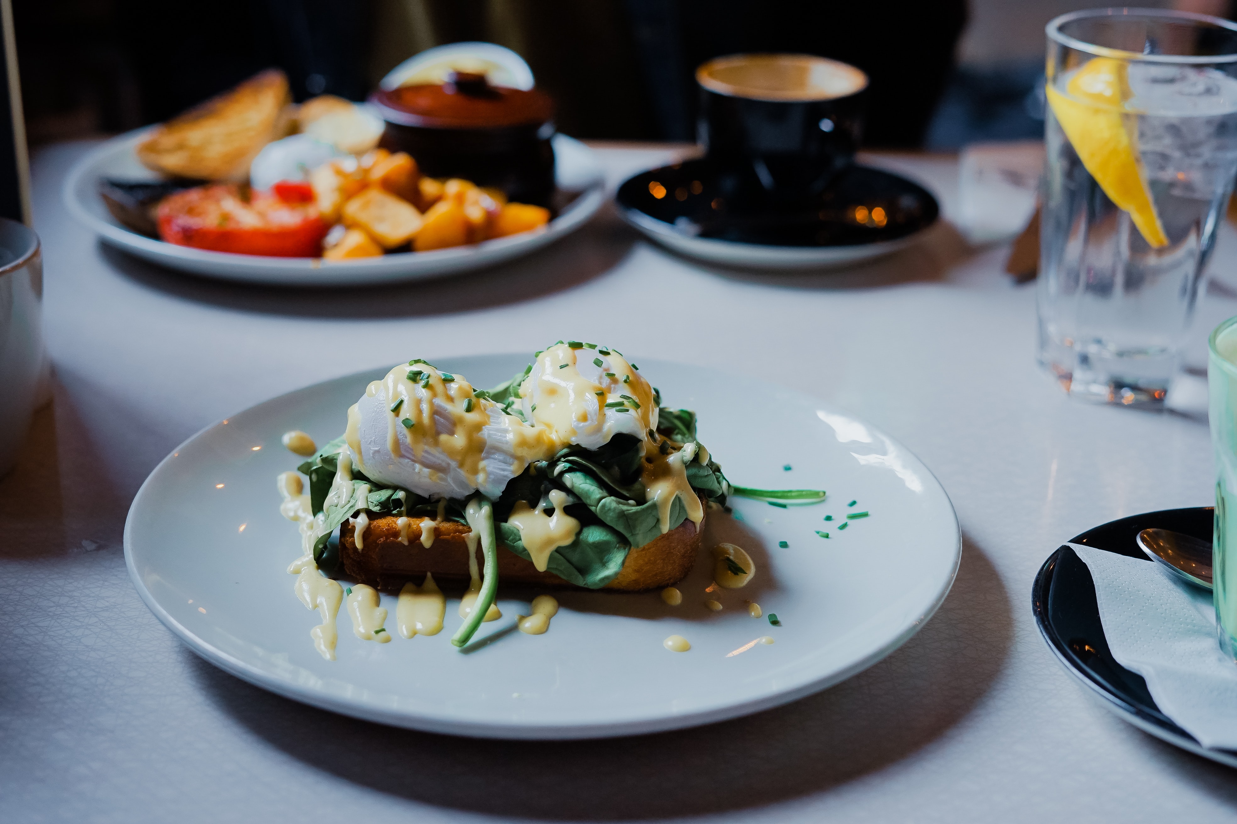 two poached eggs on siced bread topped with hollondaise sauce